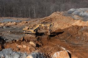 Silver Hill Quarry: A Caterpillar 385B strips overburden to prepare for blasting.