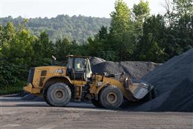 Warren Asphalt: A Caterpillar 966M loader retrieves aggregate from stockpiles within Warren Asphalt's property. 