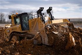 Harrisburg Division: A Caterpillar D8T strips material for a pad.