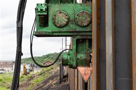 Structures Division: A Structures Division crew uses a ICE hammer to drive sheet piling.