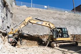 Structures Division: A Structures Division crew installs anchors into a wall. 