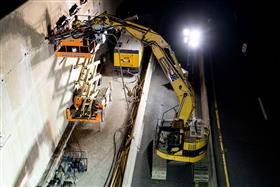 Structures Division: A Structures Division crew works on anchoring a wall along a busy highway.