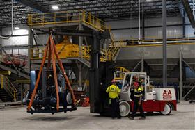 Easton Block & Supply: A new piece of machinery is moved into place inside the new plant. 