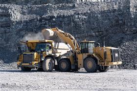 Naceville Quarry: A Caterpillar 988K loads a Komatsu HD465 with shot rock in Naceville Quarry's pit.