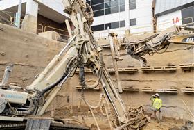 Structures Division: A Structures Division crew places a piece of casing on the drill to continue installing micropiles at Lehigh Valley International Airport. 