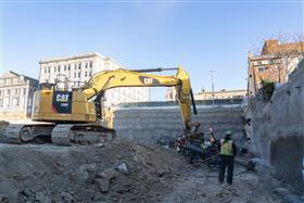 Structures Division: A Structures Division team drills anchors into place along a shotcrete wall.