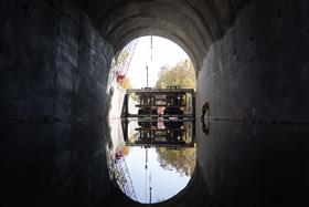 Structures Division: A Structures Division crew utilizes two large Taylor forklifts to move and place precast concrete box culverts in a tunnel. 