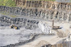 Drilling Division: A drill works on a bench at Naceville Quarry. 